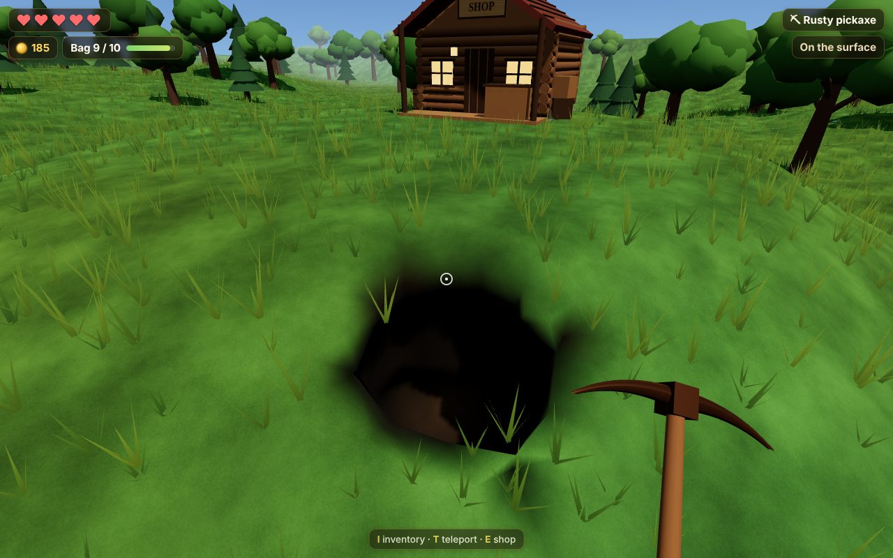A fresh hole dug in a grassy field, with a pickaxe in front and the log cabin shop behind, among trees